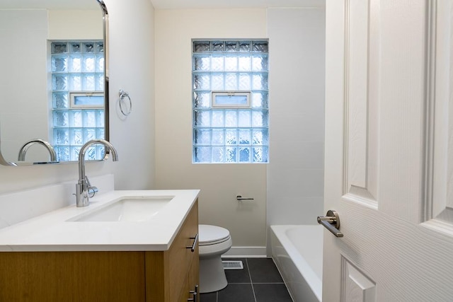 full bath featuring vanity, toilet, tile patterned floors, a tub, and visible vents