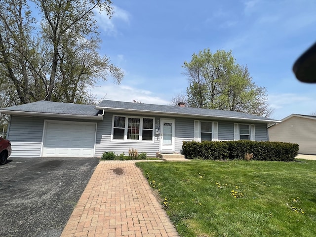 ranch-style home with an attached garage, a front yard, and aphalt driveway