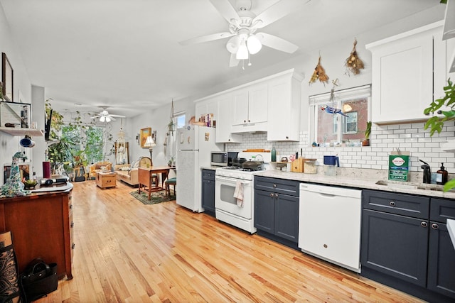 kitchen with ceiling fan, white appliances, white cabinets, and backsplash