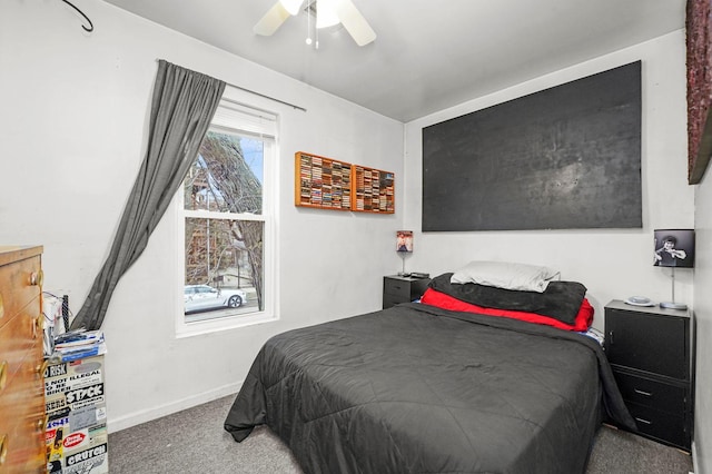 carpeted bedroom with ceiling fan and baseboards