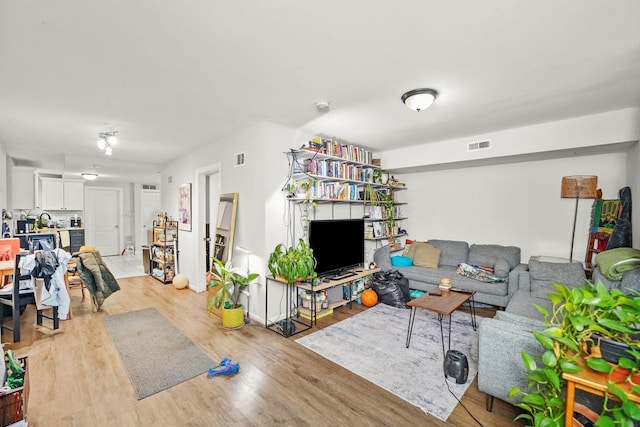 living room featuring visible vents and light wood-style flooring