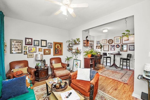 living room with wood finished floors and a ceiling fan