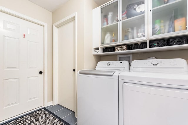 2245 Lakeside Dr, Aurora, IL 60504 - laundry room with cabinet space, separate washer and dryer, and dark tile patterned floors