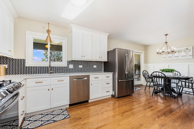 2245 Lakeside Dr, Aurora, IL 60504 - kitchen featuring a chandelier, decorative light fixtures, appliances with stainless steel finishes, light countertops, and white cabinets