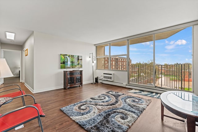 living room with baseboards, a wall mounted AC, and wood finished floors