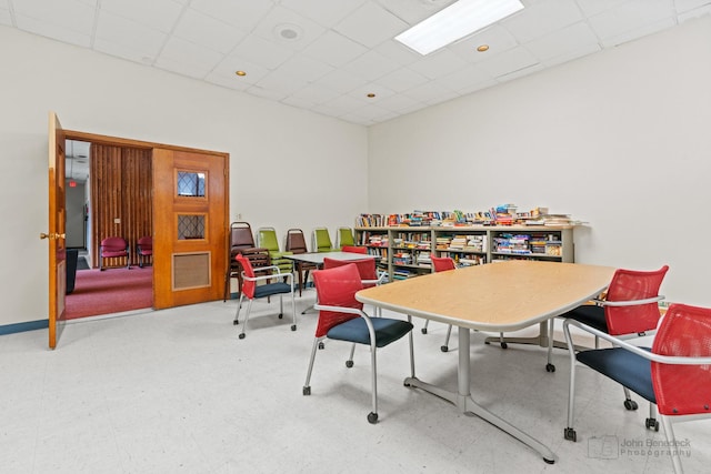 rec room featuring a drop ceiling and tile patterned floors