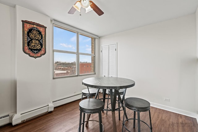 dining room with baseboards, ceiling fan, and wood finished floors