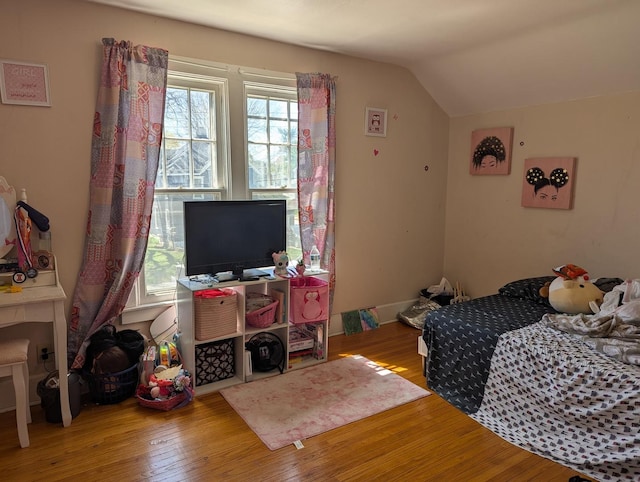 bedroom with lofted ceiling and wood-type flooring