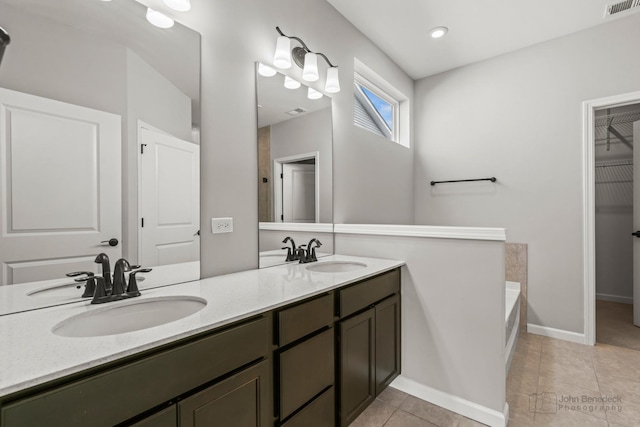 full bath featuring visible vents, a sink, a bath, and tile patterned floors