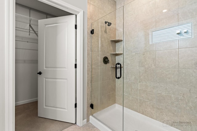 bathroom featuring baseboards and a stall shower