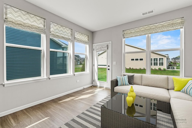 sunroom with visible vents and a healthy amount of sunlight