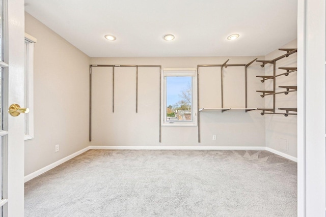 interior space featuring carpet flooring and baseboards