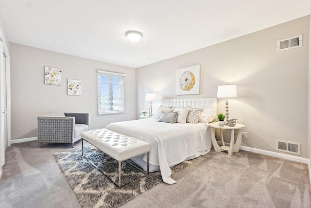 bedroom with baseboards, visible vents, and carpet flooring