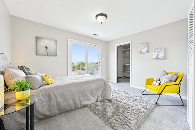 bedroom with access to exterior, visible vents, carpet floors, and baseboards