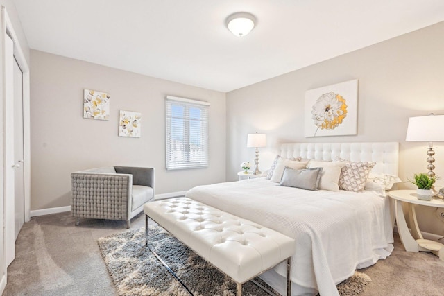 bedroom featuring baseboards and light carpet