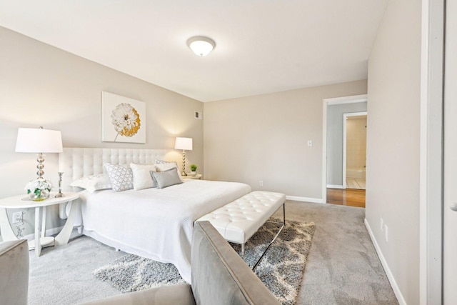 carpeted bedroom with visible vents and baseboards