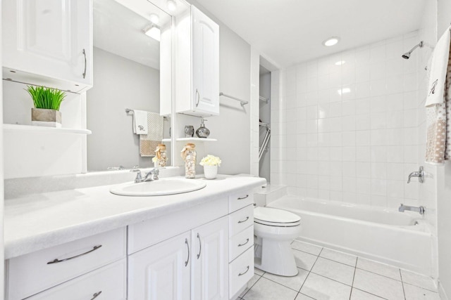 bathroom featuring toilet, vanity, shower / bath combination, and tile patterned floors