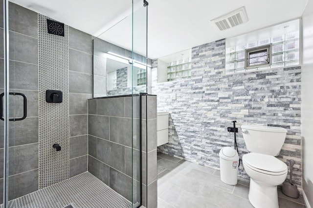 bathroom with tile patterned floors, visible vents, a shower stall, and toilet
