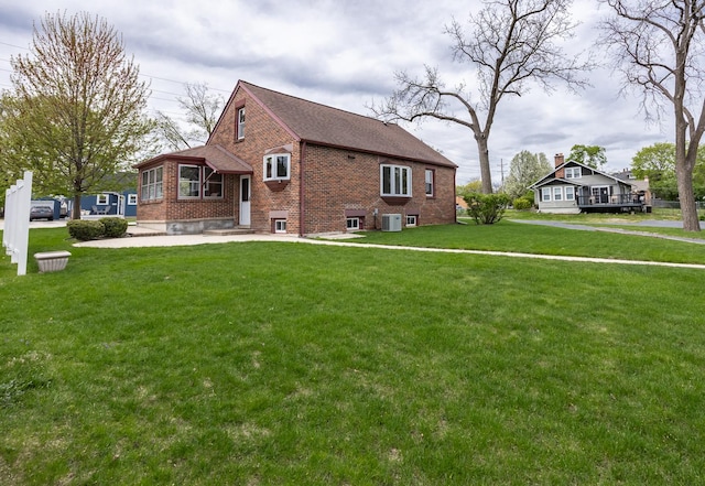 exterior space with a lawn, brick siding, and entry steps