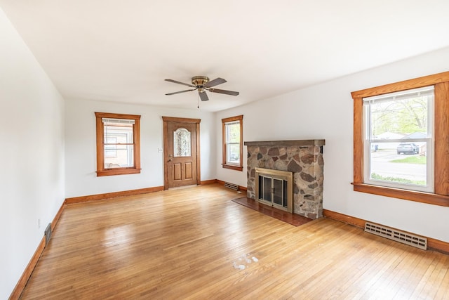 unfurnished living room with baseboards, light wood-style flooring, and visible vents