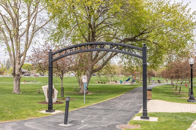 surrounding community with a yard and playground community