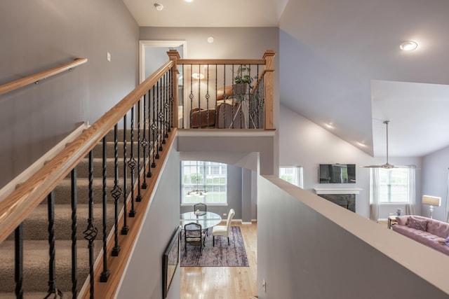 825 Canton Dr, Oswego, IL 60543 - staircase featuring recessed lighting, wood finished floors, and a fireplace