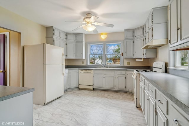 kitchen featuring a healthy amount of sunlight, a ceiling fan, white appliances, and marble finish floor