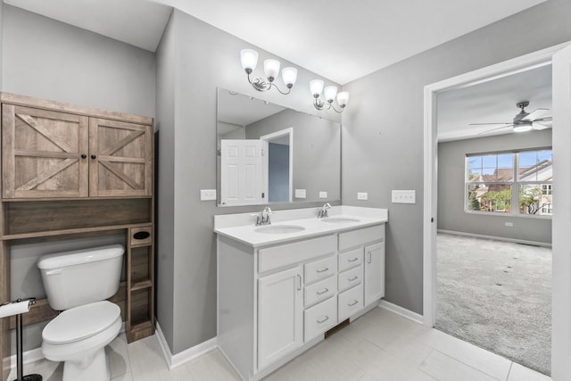 full bathroom featuring a sink, baseboards, toilet, and double vanity