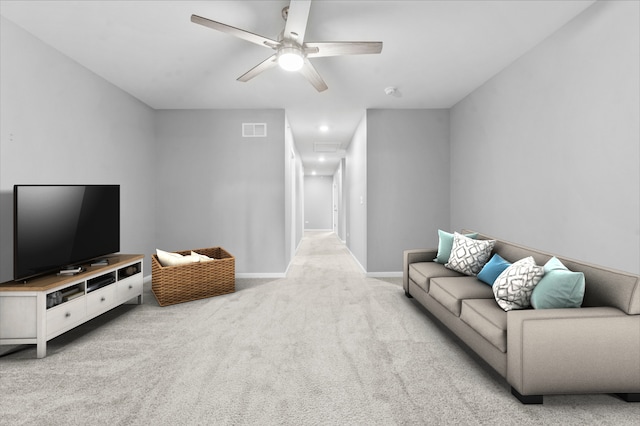 living area with visible vents, a ceiling fan, baseboards, attic access, and carpet flooring