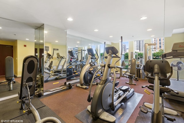exercise room featuring a wall of windows and recessed lighting