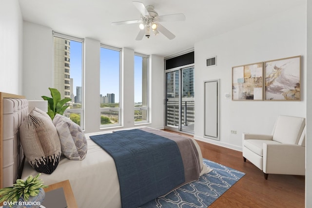 bedroom featuring wood finished floors, ceiling fan, access to exterior, and baseboards