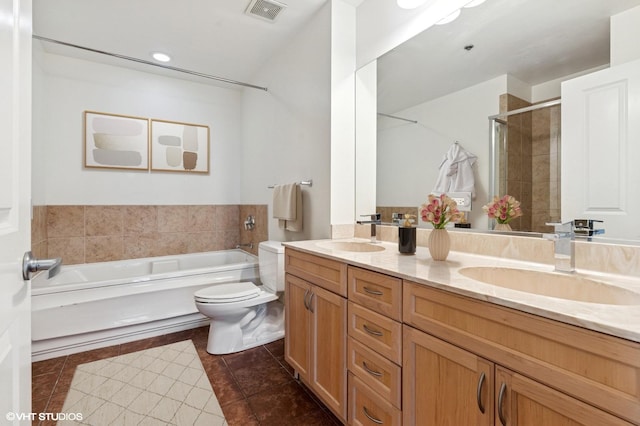bathroom with double vanity, tile patterned flooring, a stall shower, toilet, and a garden tub