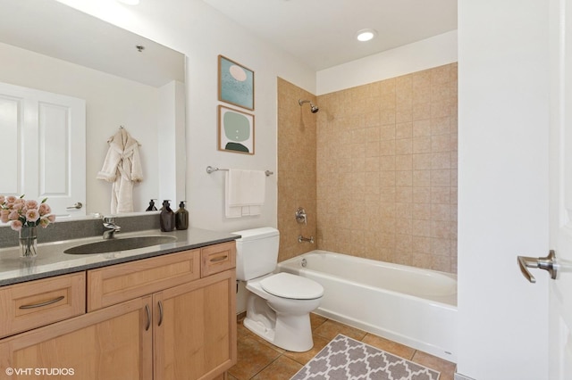 bathroom featuring tile patterned floors, toilet, vanity, and bathtub / shower combination