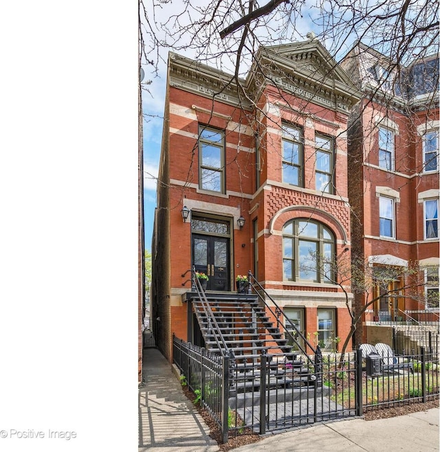 1833 W Evergreen Ave, Chicago, IL 60622 - view of front of house featuring french doors, stairs, fence private yard, and brick siding