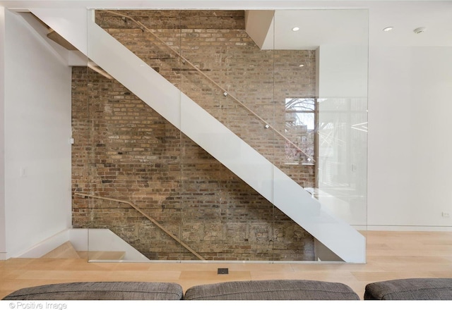 1833 W Evergreen Ave, Chicago, IL 60622 - staircase featuring brick wall, baseboards, and wood finished floors
