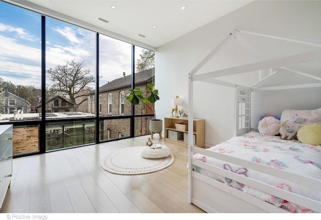 1833 W Evergreen Ave, Chicago, IL 60622 - bedroom with recessed lighting, expansive windows, and wood finished floors