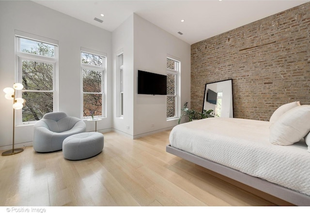 1833 W Evergreen Ave, Chicago, IL 60622 - bedroom with baseboards, brick wall, wood finished floors, and a towering ceiling