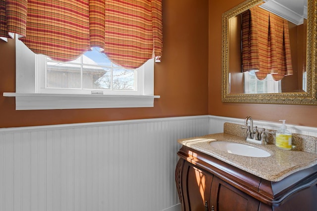 bathroom featuring a wainscoted wall and vanity