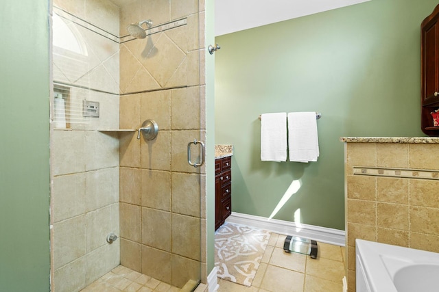 full bathroom featuring tile patterned floors, baseboards, and a shower stall
