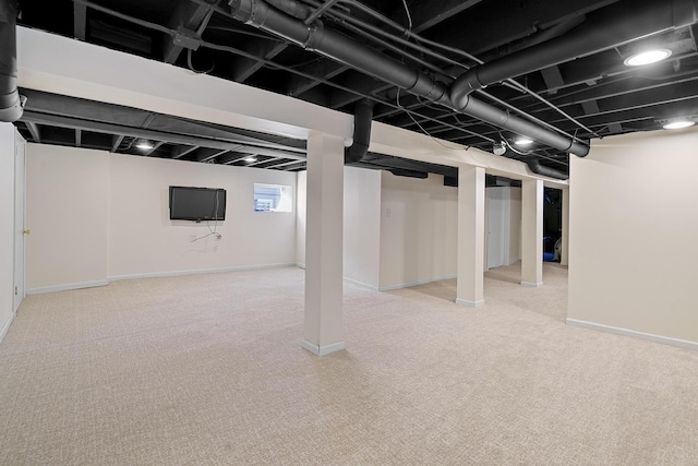 basement with light carpet and baseboards