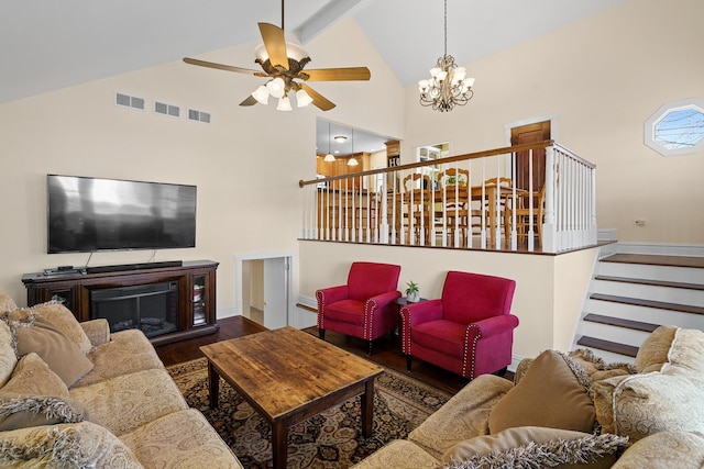 living room with stairway, high vaulted ceiling, visible vents, wood finished floors, and ceiling fan with notable chandelier