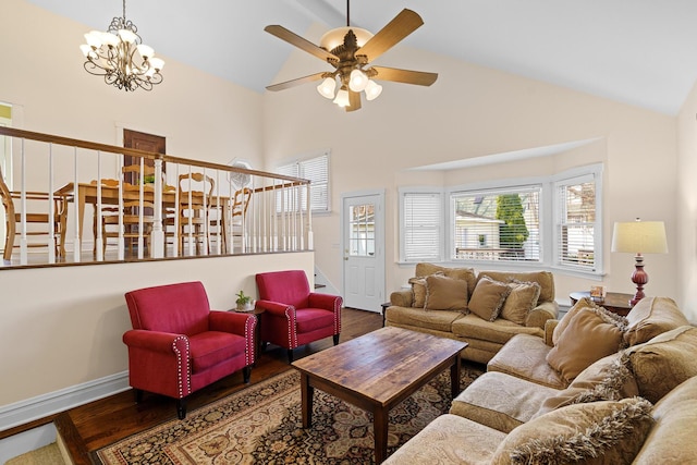 living room featuring baseboards, high vaulted ceiling, wood finished floors, and ceiling fan with notable chandelier