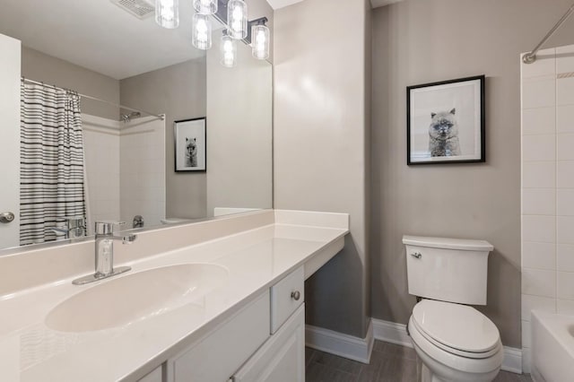 bathroom featuring visible vents, shower / bath combo, vanity, baseboards, and toilet