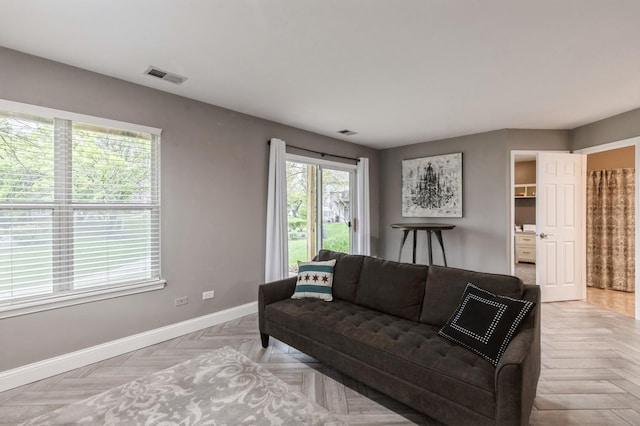 living room featuring baseboards and visible vents
