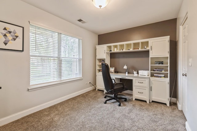 home office featuring visible vents, baseboards, and light carpet