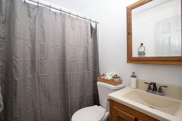 full bath featuring curtained shower, vanity, and toilet