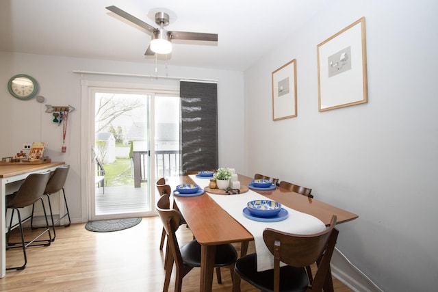 dining space with light wood-type flooring and a ceiling fan
