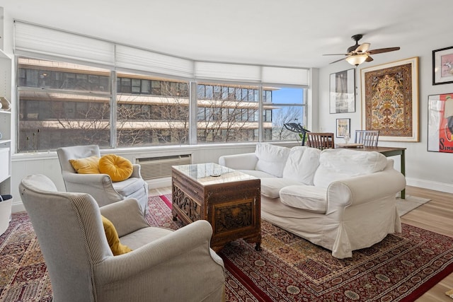 sunroom with wood finished floors and baseboards