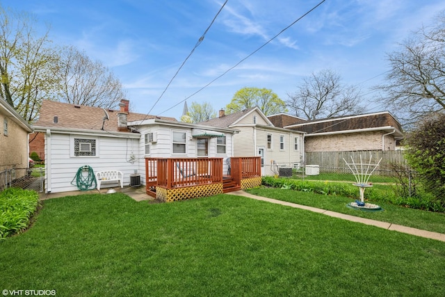 back of house featuring a yard, a deck, fence, and cooling unit