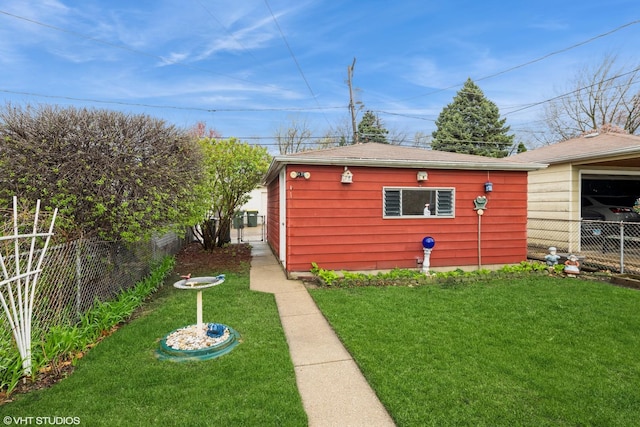 view of yard with fence and an outbuilding